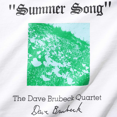 White t-shirt print reading "Summer Song" above a green and pale blue grassy square, with The Dave Brubeck Quartet and a signature below.