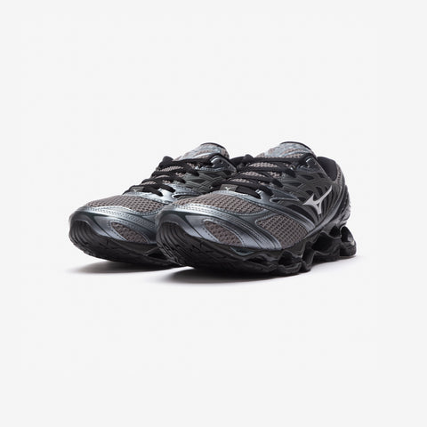Pair of grey and black running shoes with mesh uppers, black laces, and sculpted wave-like black midsoles, shown from the front three-quarter angle.
