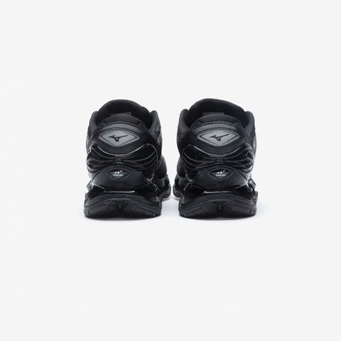 Rear view of a pair of black athletic running shoes with layered mesh and sculpted heel counters on a white background