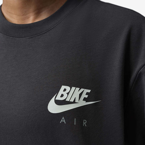 Close-up of a black crew-neck t-shirt with a white Swoosh logo above the words BIKE and AIR printed in white.