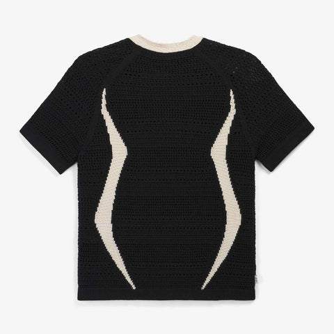 Back view of a black short-sleeve open-knit crochet top with cream wave-shaped stripes down the back and a cream crew neck trim.