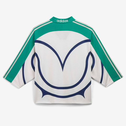 Back view of a white mesh long-sleeve jersey with green raglan sleeves and shoulders, navy curved graphic lines, and the adidas wordmark at the collar.