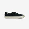 Black suede slip-on sneaker with a white rubber sole and a small logo tab on the heel, shown in profile on a white background.